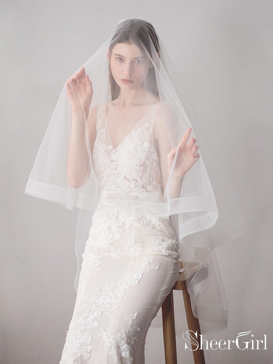 https://www.sheergirl.com/cdn/shop/products/Two-Layers-Ivory-Tulle-Knee-Length-Wedding-Veils-ACC1050-3_5ae0c2d6-f457-4938-8398-13385574835e_1200x.jpg?v=1631816875